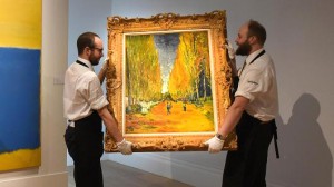 Getty Images Gallery technicians carry Vincent Van Gogh's 'L'Allee des Alyscamps', at Sotheby's in London